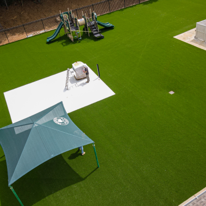 Playground with AST Ameriplay artificial turf, shade canopy, and play equipment at Primrose Schools Atlanta GA