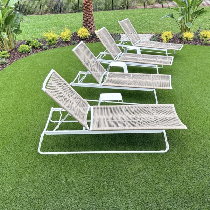 Synthetic turf installation in Florida, backyard lounge chairs. AST Fresh Cut