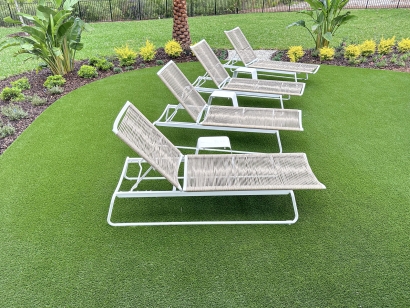 Synthetic turf installation in Florida, backyard lounge chairs. AST Fresh Cut