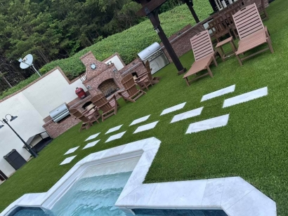 Elegant outdoor living space Toccoa Georgia with jacuzzi, seating area, and artificial grass - American Syn-Turf Supreme-60 premium synthetic lawn for pool decks and patios